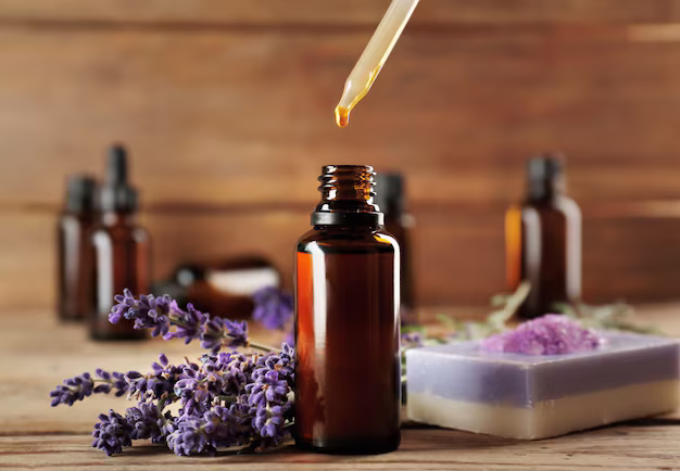 Lavender essential oils bottle with fresh flowers and lavender soap