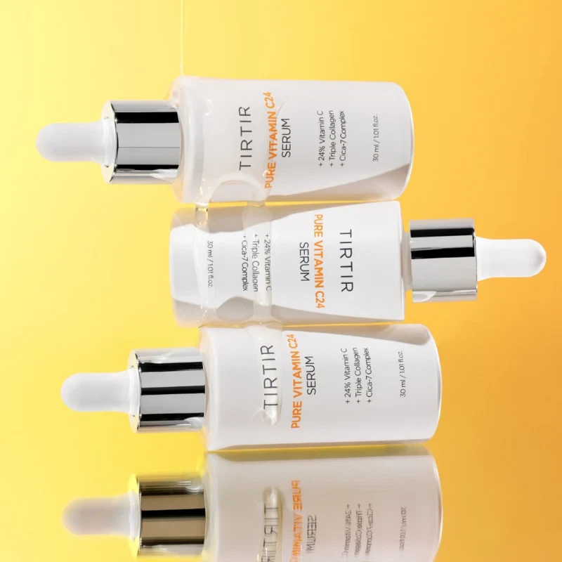 TirTir Pure Vitamin C24 serum stacked in a tier and dripping with water.