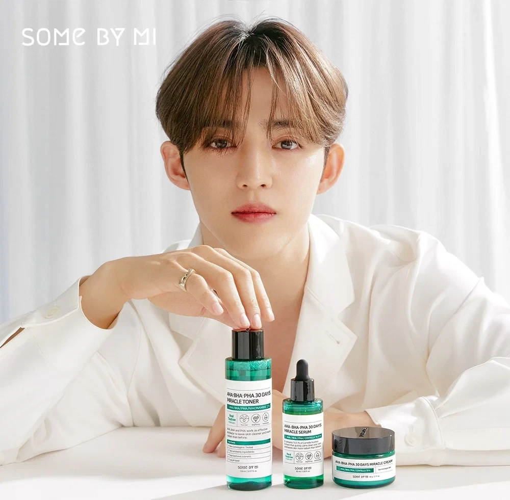 Model posing with Some By Mi 30 Days Miracle skincare line