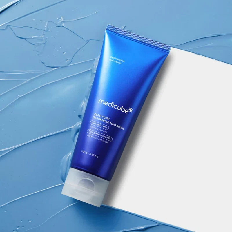 Medicube Zero Pore Blackhead Mud Facial Mask swiping through layer of blue mud