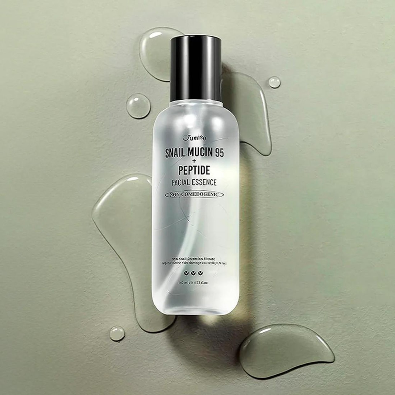 Jumiso Snail Mucin 95 + Peptide Facial Essence sitting on grey background with water spots