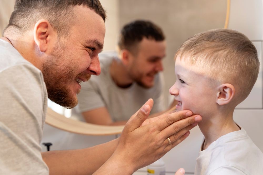 Father teaching his son how to shave
